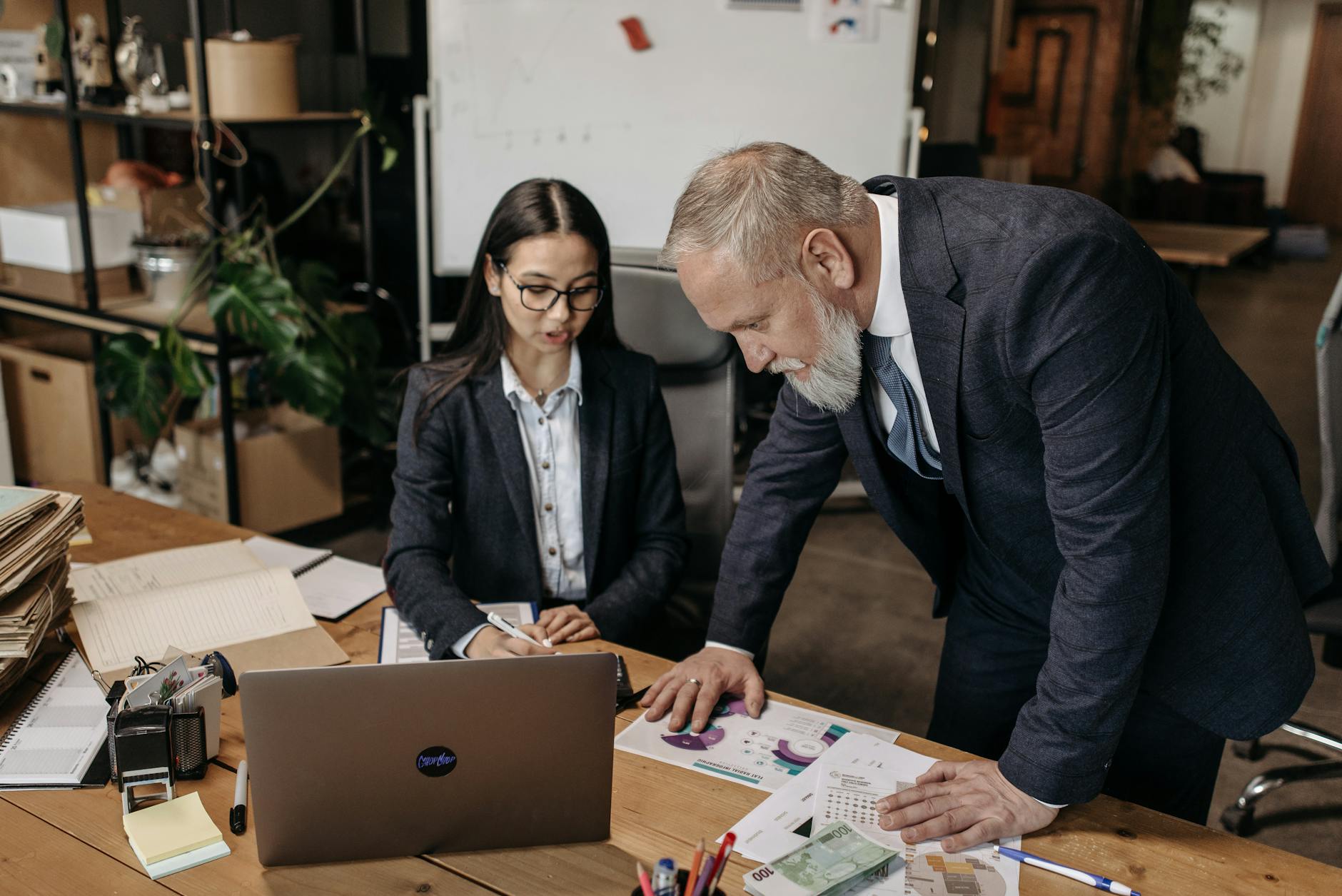 small business owner reviewing website project on laptop with developer