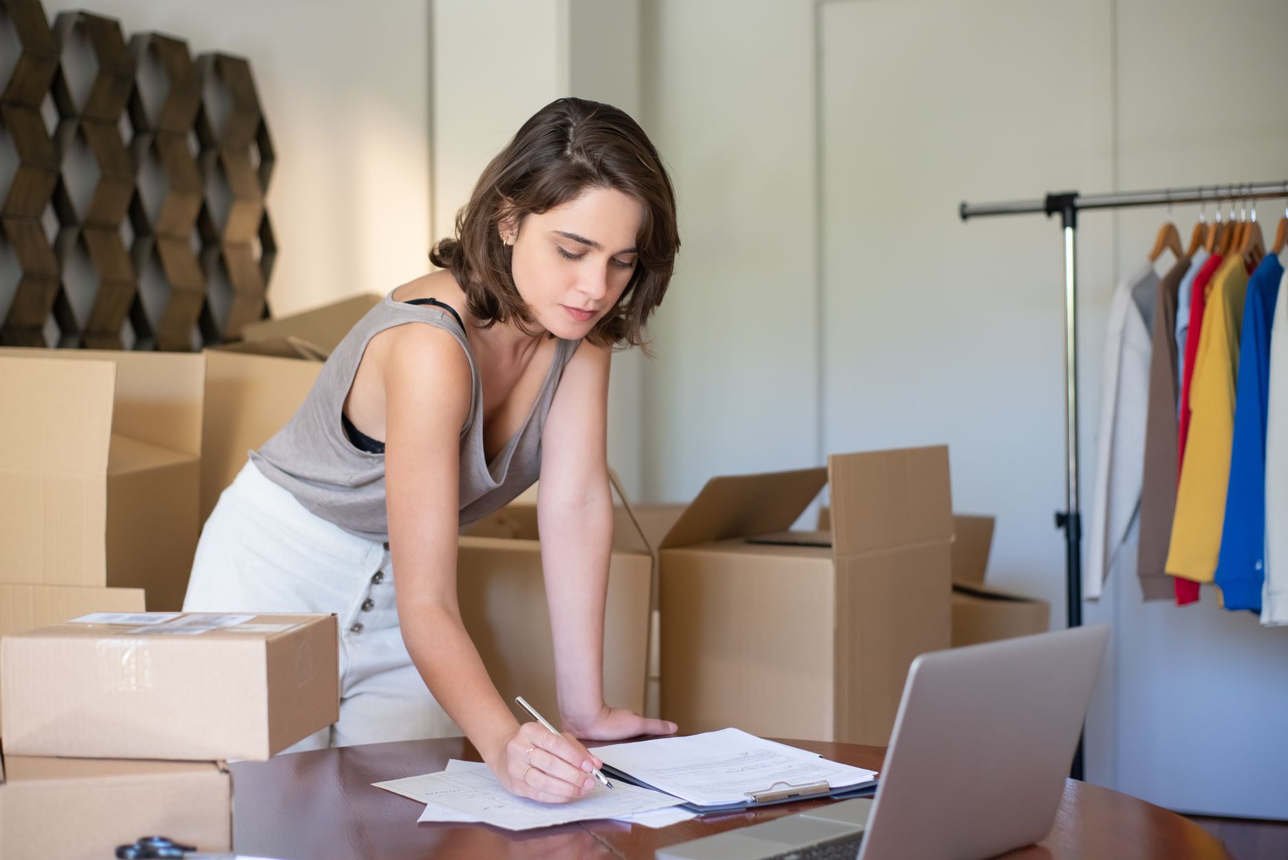 small business owner managing online store laptop