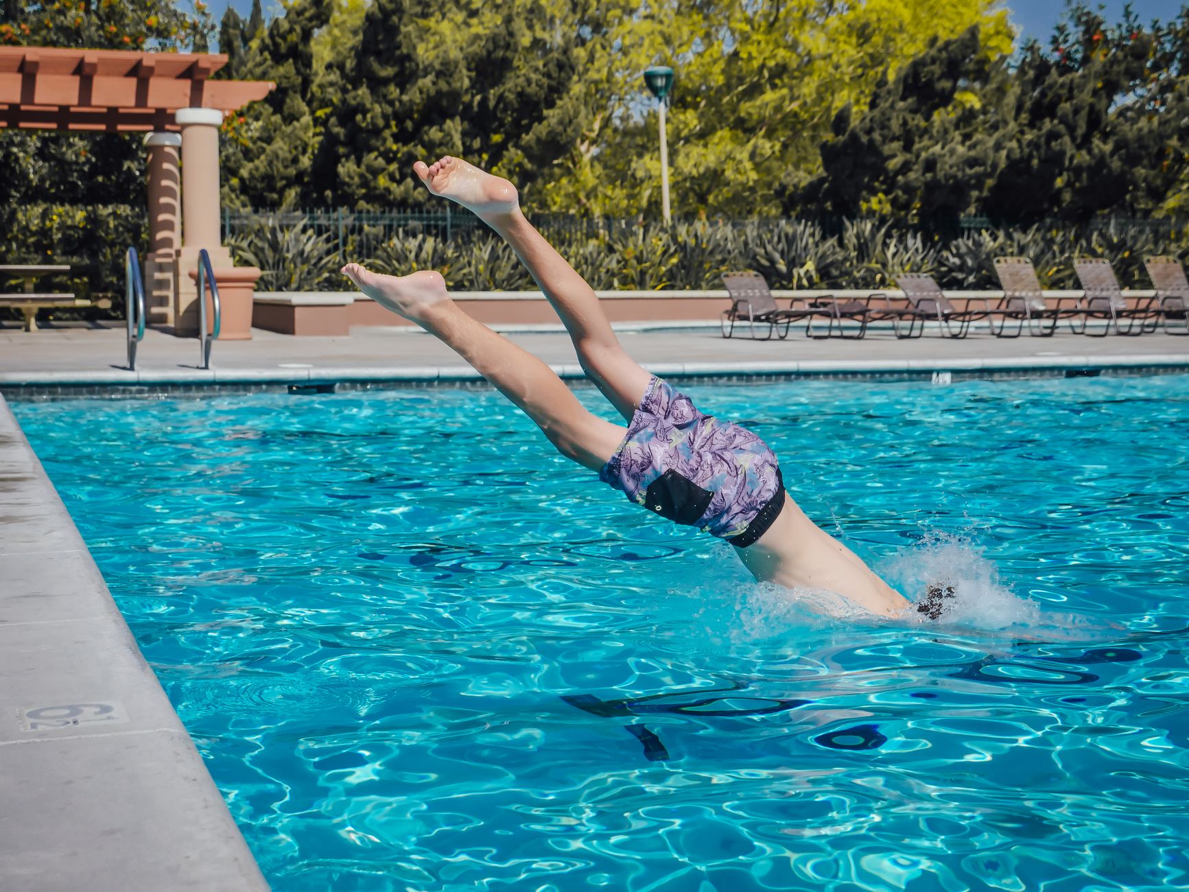 person entering cold plunge pool outdoor summer heat
