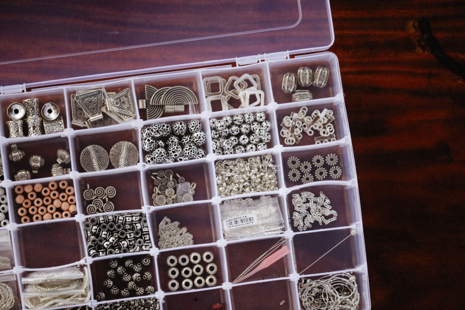 jewelry storage box with gold and silver jewelry organized in compartments
