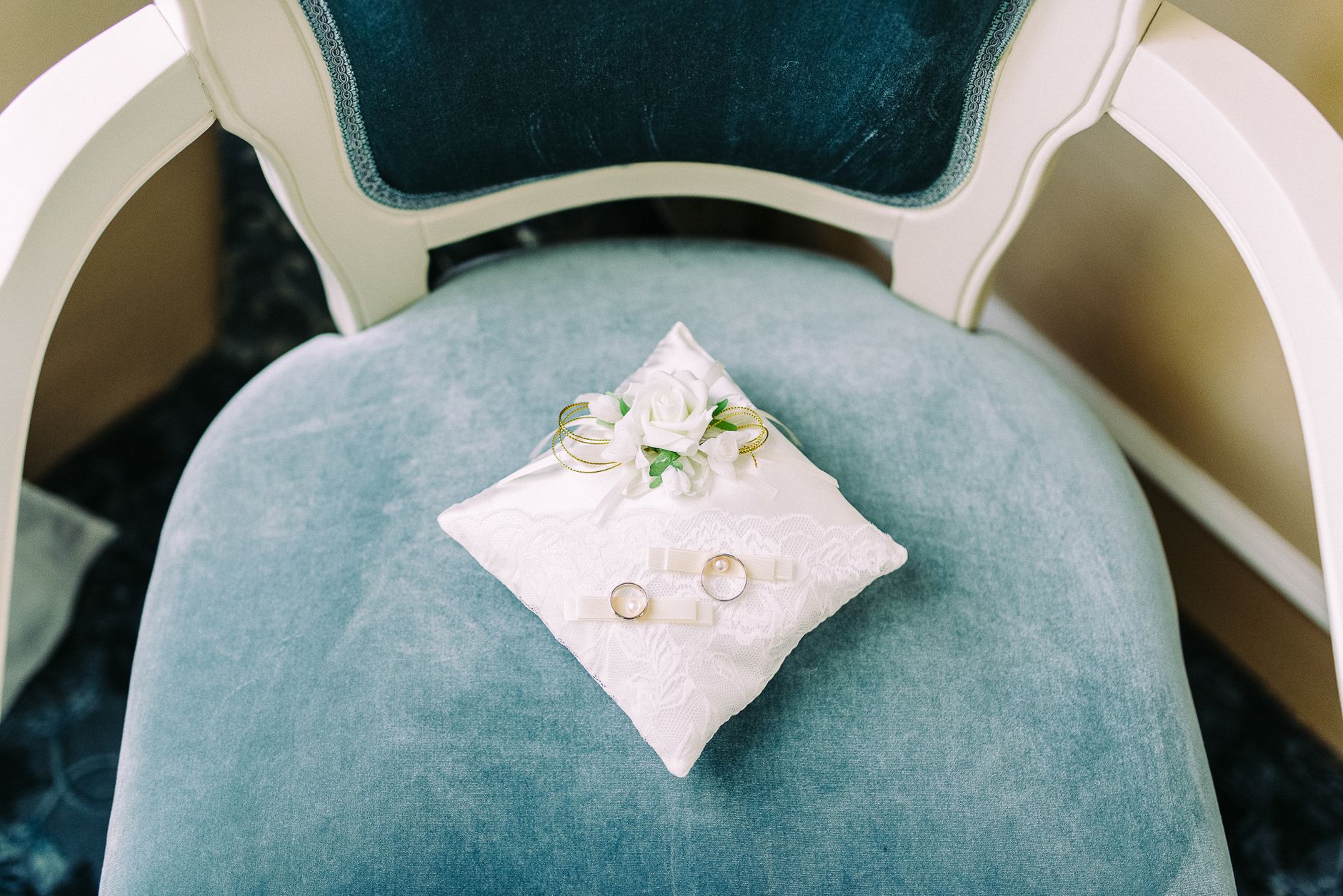 yellow gold and white gold wedding rings on velvet cushion