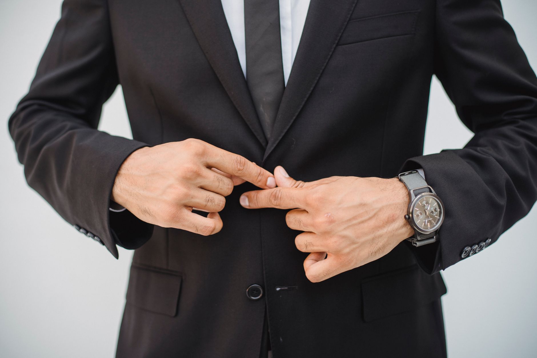 elegant man wearing wristwatch with suit