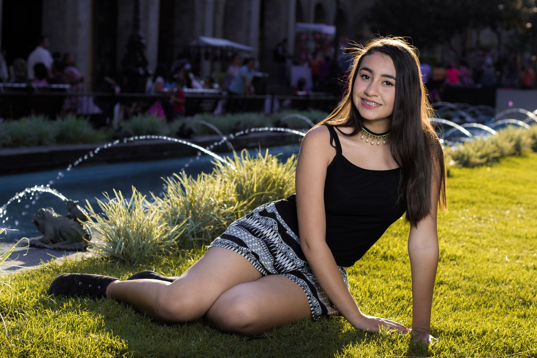 teenage girl wearing thin layered bracelets and delicate necklace