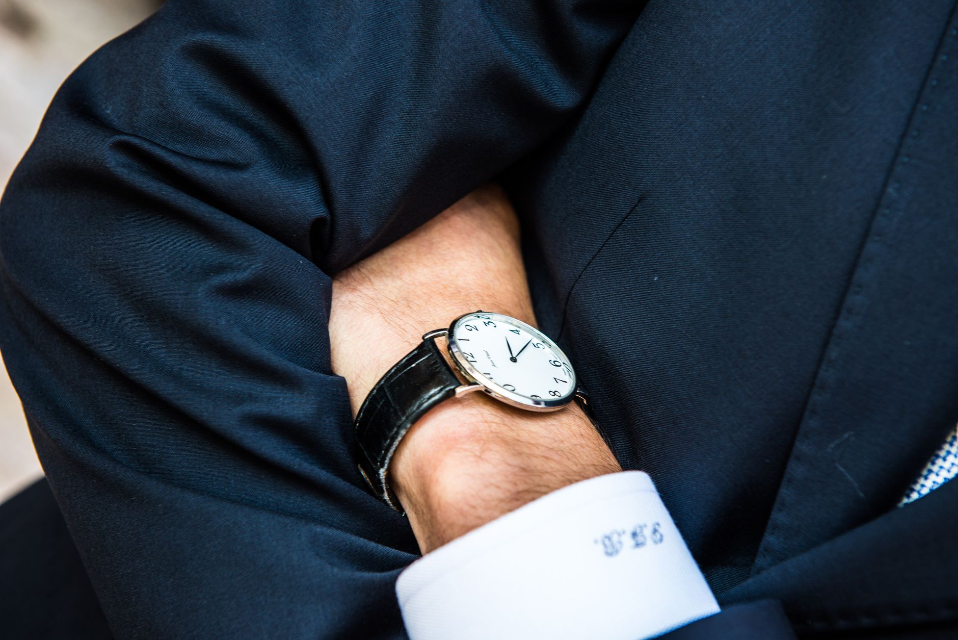 classic wristwatch close up on suit sleeve
