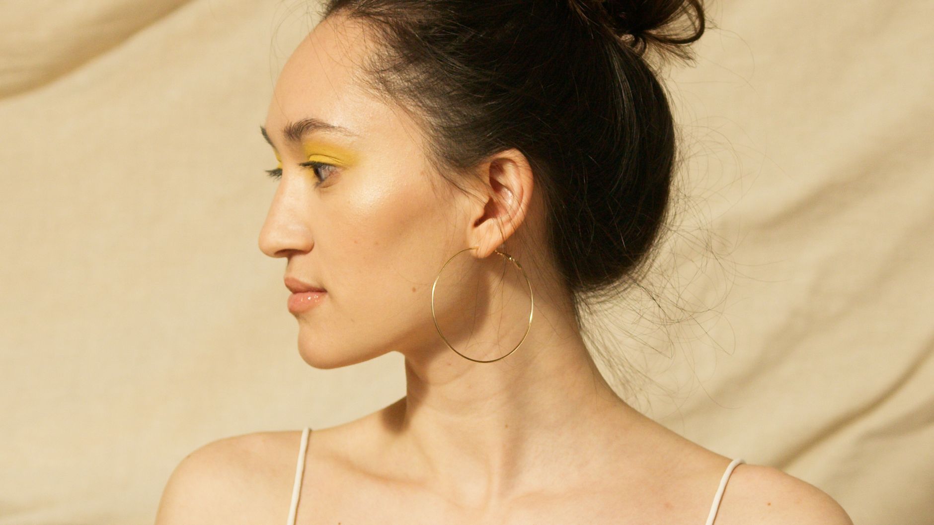 close up gold hoop earrings on model